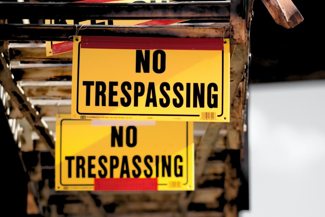 No Trespassing sticker on brown surface