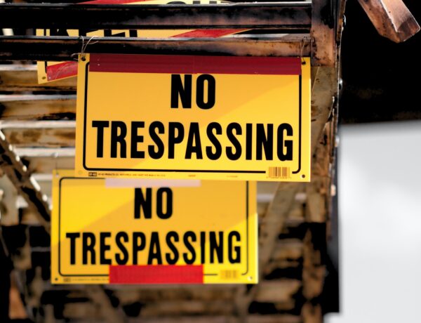 No Trespassing sticker on brown surface