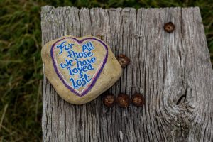 a heart shaped rock with a message written on it