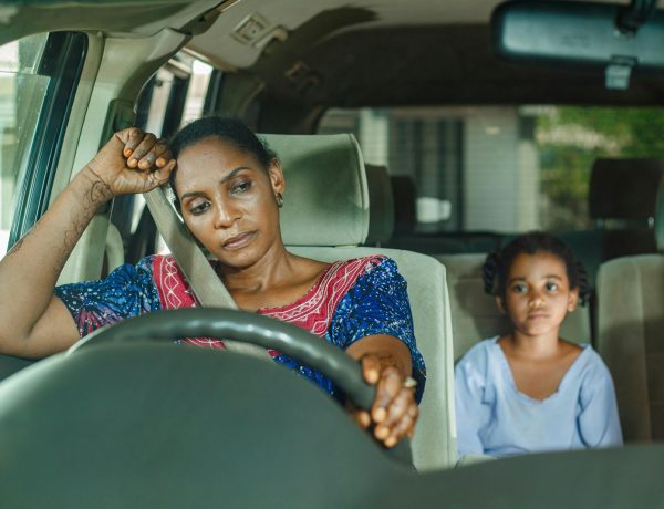 a woman and a child sitting in a car