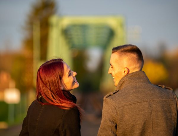 man and woman standing side by side during daytime