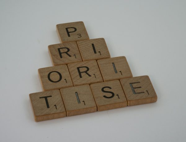 a scrabbled wooden block spelling the word prize